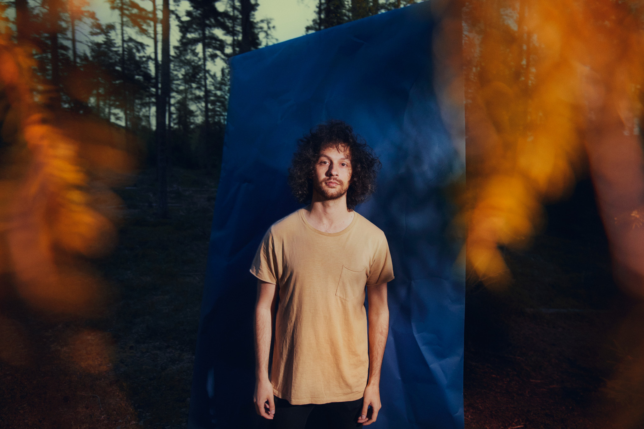 Aleksander infront of a blue background